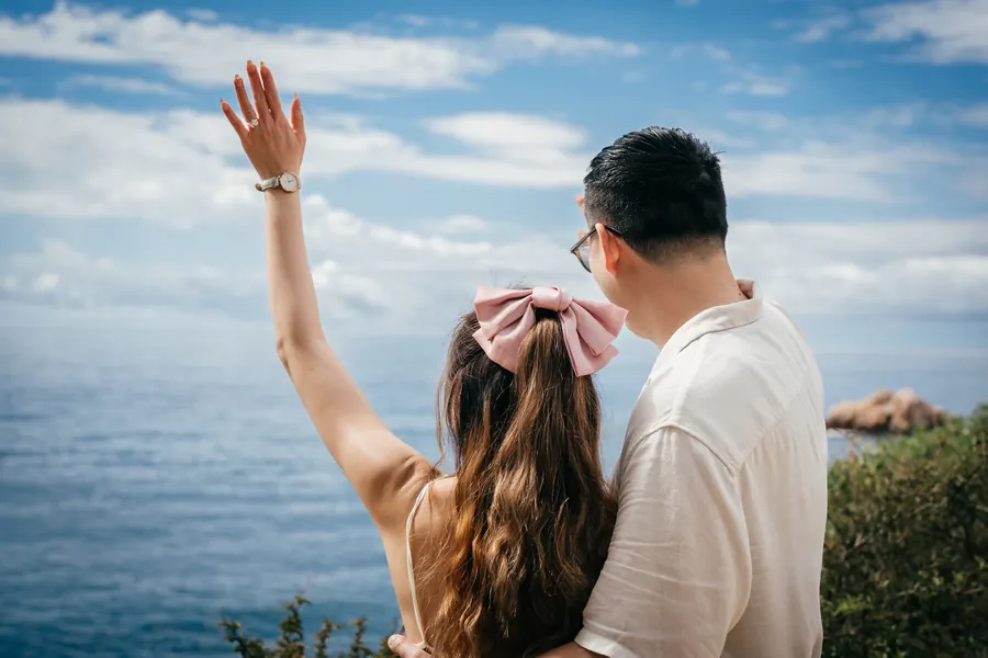 She raises her hand with the ring towards the sea