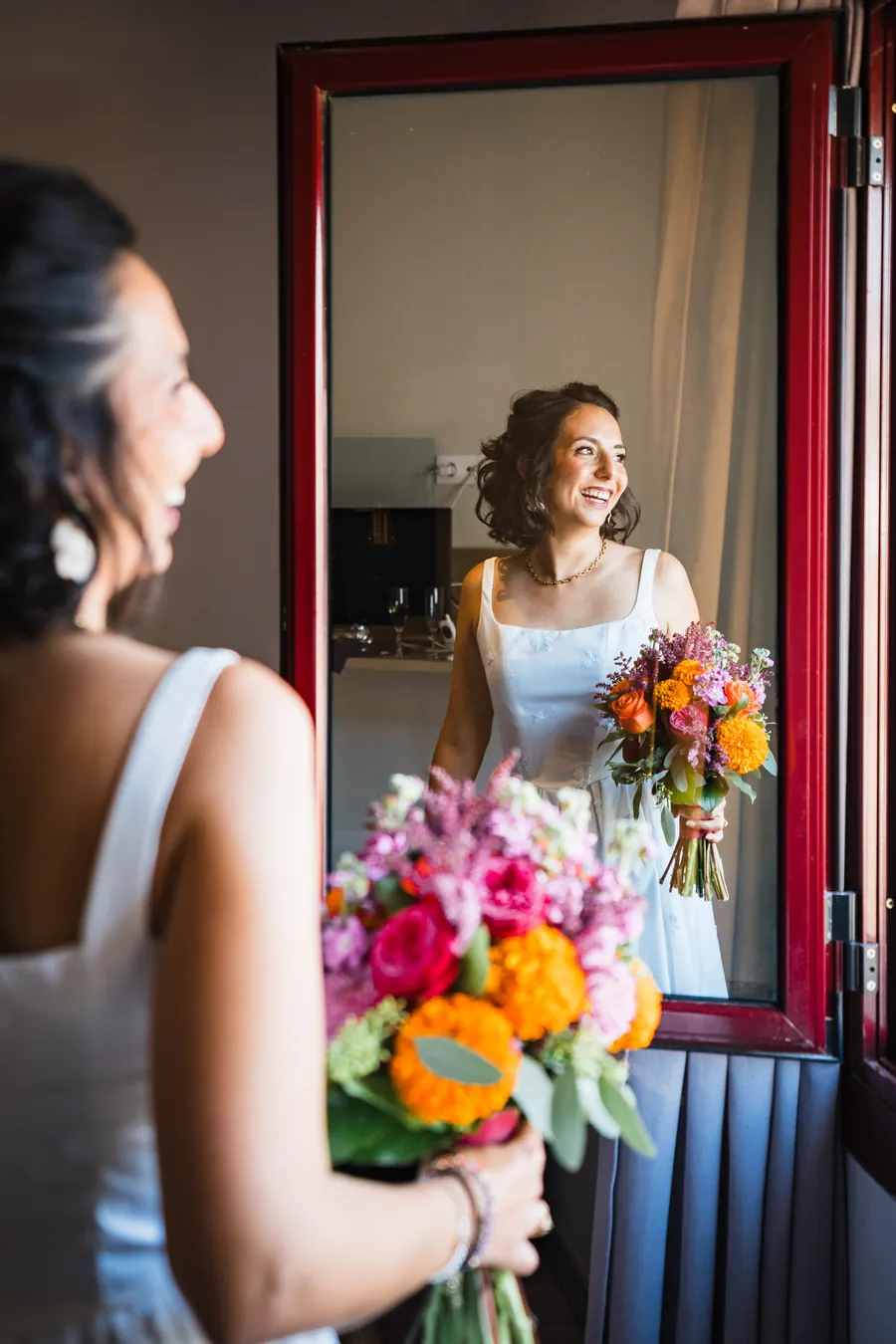 The bride with her bouquet, reflected in a mirror
